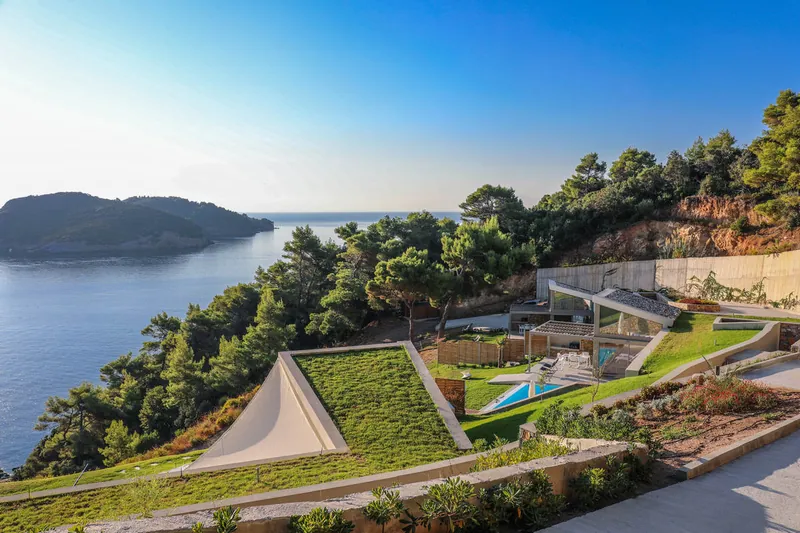 The villas with their green roofs among the pines, the sea and the islands beyond