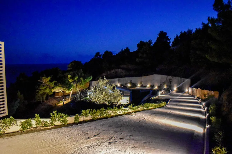 The villas’ lit driveway at night