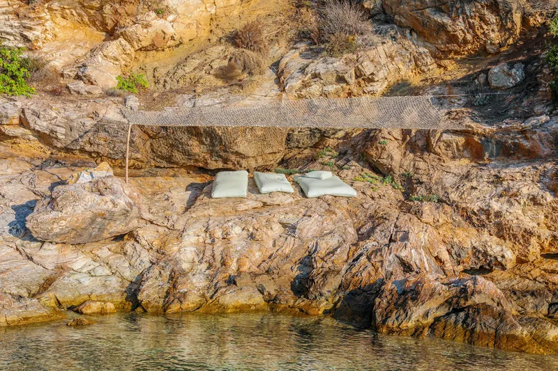 Sunbeds on the rocks by the sea