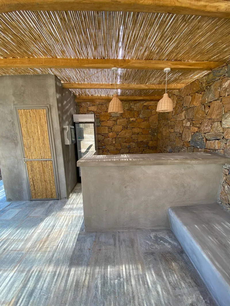 The beach hut with its stone wall and reed roof