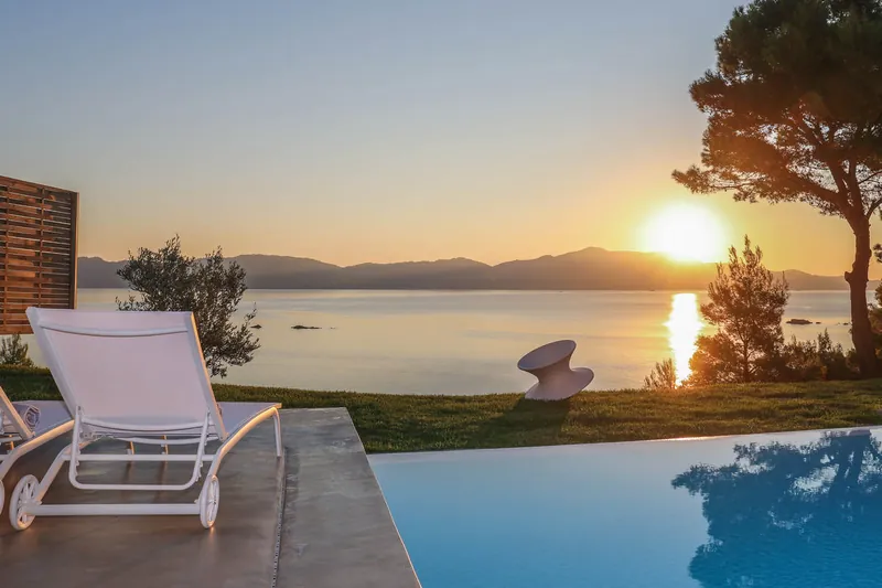 Sunset over the sea from Villa Iioni’s infinity pool