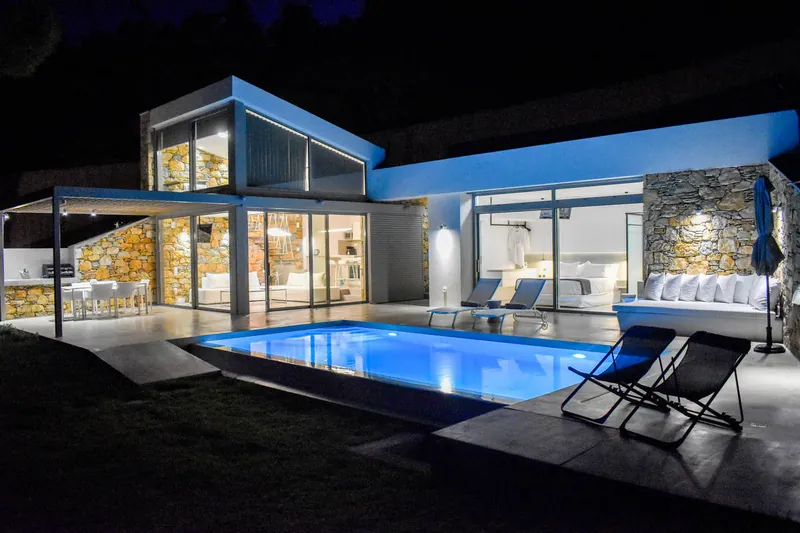 The villa and the lit pool at night