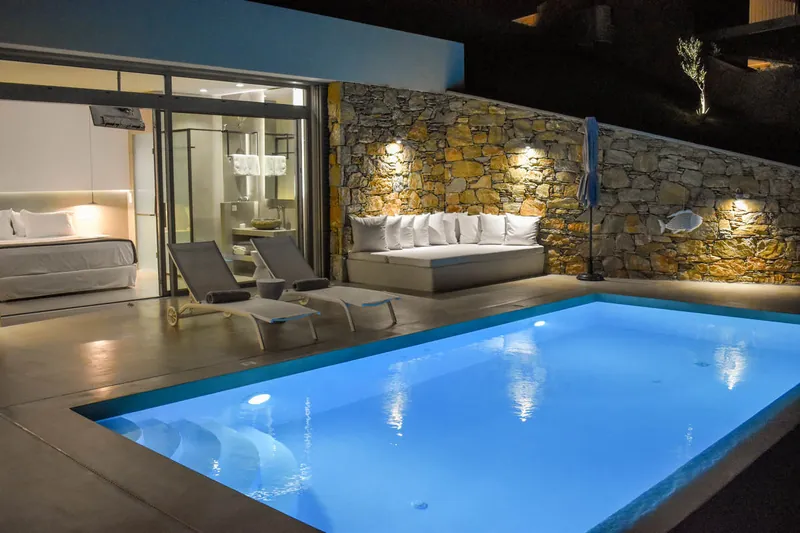 The pool at night by the stone wall
