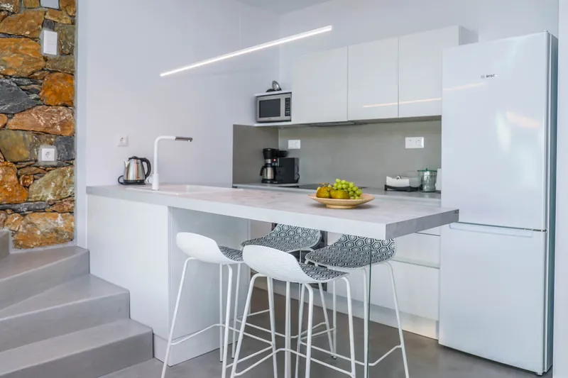 The white kitchen and its bar stools