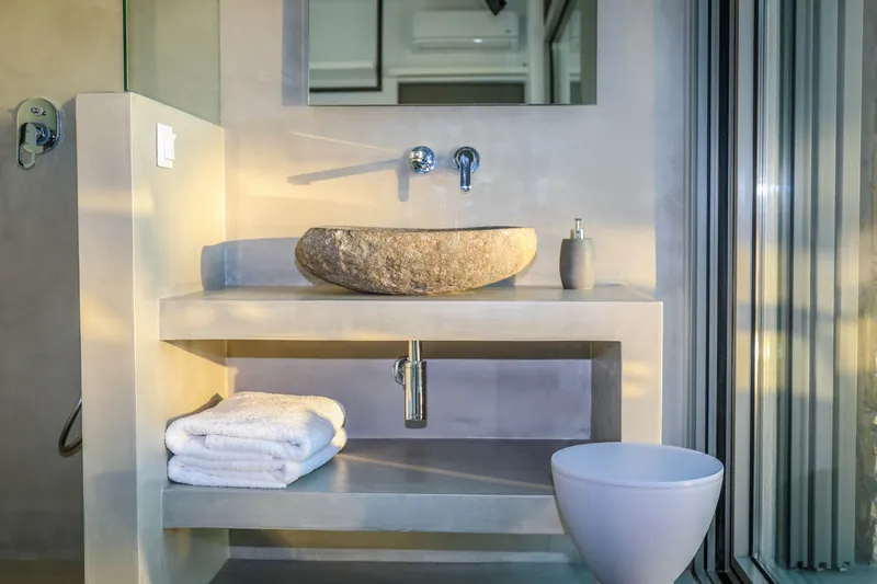 A stone basin and the shower