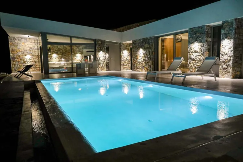 The villa and the lit pool at night