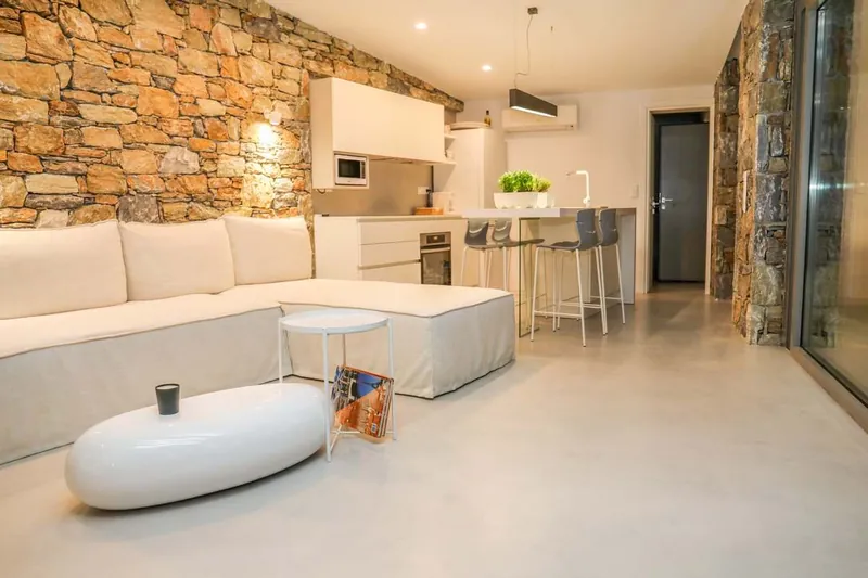 The living room with its stone wall and sofa