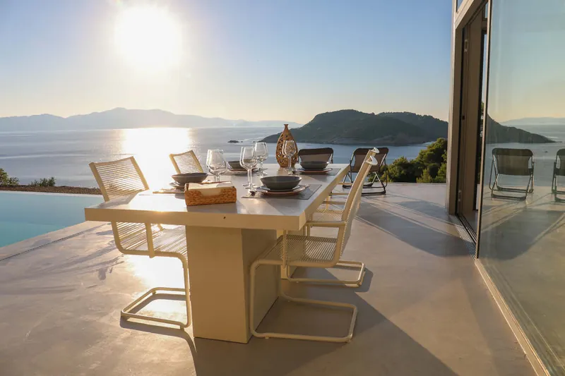 The set table on the terrace in the evening sun